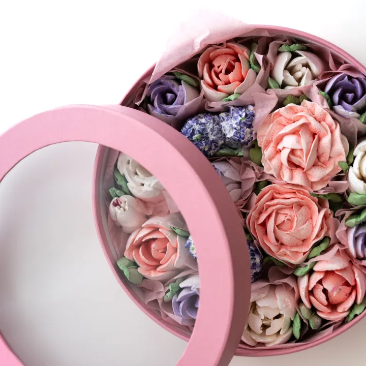 Pastel roses arranged in a round gift box